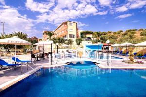 a swimming pool with a bridge in a resort at Hotel Diamond in Limenaria