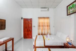 Postel nebo postele na pokoji v ubytování Ngoc Qui Bungalow