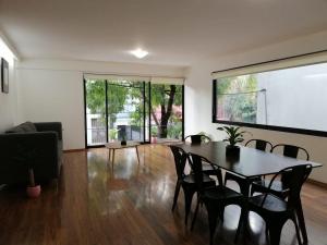 a living room with a dining room table and chairs at Nejapa Irrigación Embajada Americana in Mexico City +28 photos