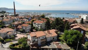 an aerial view of a city with houses and the ocean at Arcobaleno isolano in Izola +5 photos