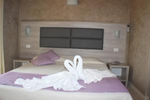 Postel nebo postele na pokoji v ubytování Hotel Miralago
