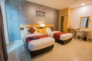 Postel nebo postele na pokoji v ubytování Hotel Adya Express Chenang