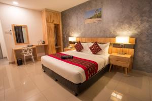 Postel nebo postele na pokoji v ubytování Hotel Adya Express Chenang