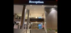 a lobby of a building with stairs and a sign at Alshaheen Suites in Jeddah