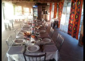 a long table with plates of food on it at Inn Sogdiana in Panjakent