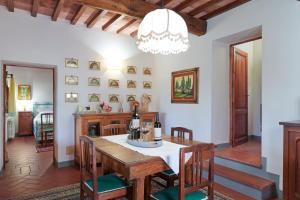 a kitchen and dining room with a table and chairs at Santa Maria a Poneta in Barberino di Val dʼElsa