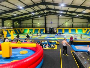 a gym with people playing in an indoor trampoline at Ingoldmells, The Grange Holiday Park 3-Bedroom Caravan in Skegness