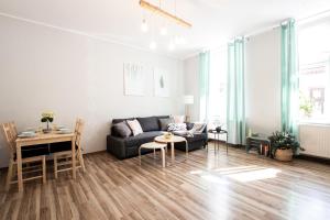 a living room with a couch and a table at Apartamenty KDN in Bielsko-Biała