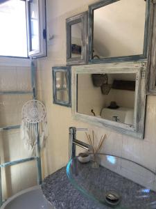 a bathroom with a sink and a mirror at Stella's Attic Room in Toirano