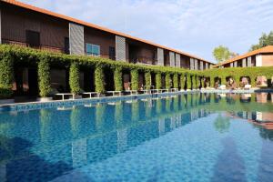 a large swimming pool in front of a building at Countryside Phu Quoc Resort in Phu Quoc