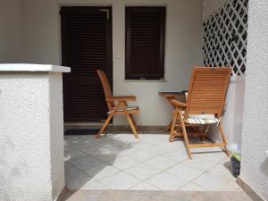 two chairs and a table on a patio at Apartments Lucija in Zadar