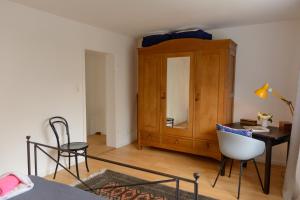 a bedroom with a desk and a cabinet and a chair at Anna's Siedlungshäusle in Herrenberg