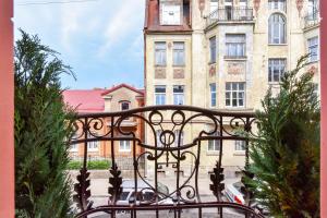 an iron balcony with a building in the background at Hotel Jugend with Self Check-in in Liepāja