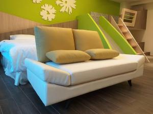 a couch with two pillows on it in a bedroom at Mesin-inn in Magong