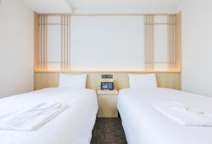Rúm í herbergi á Henn na Hotel Premier Kyoto Eki Hachijoguchimae