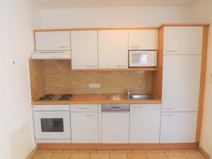 Kuchyňa alebo kuchynka v ubytovaní Apartments Scheffau