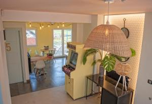 a living room with a tv and a pendant light at Amita Hotel Boutique "Only adults" in Suances