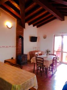 a living room with a table and chairs and a television at Mon Perin Castrum - Apartman Valentina in Bale