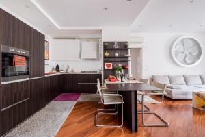 a kitchen and living room with a table and a couch at The Jasmine Terrace Retreat in Bologna