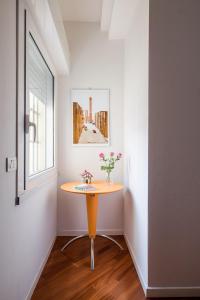 a small table in a room with a window at The Jasmine Terrace Retreat in Bologna