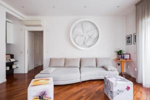 a white living room with a couch and a table at The Jasmine Terrace Retreat in Bologna