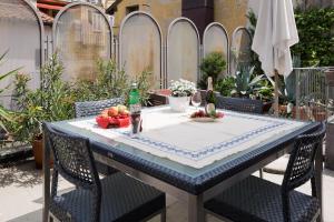 a table with a table cloth and two bottles of wine at The Jasmine Terrace Retreat in Bologna