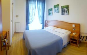 a bedroom with a large bed and a window at Hotel Mare Blu -- boutique in Pineto