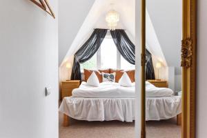 a bedroom with a large bed with a window at Spicīte in Ventspils