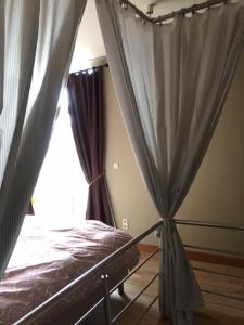 a bedroom with a bed and a window at Holiday Home Family @ home 97 in Bruges