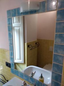 a bathroom with a tub and a sink and a mirror at La Corte di Lucina in Terralba