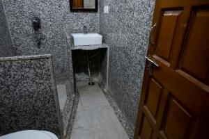 a bathroom with a sink and a toilet at Tripli Hotels Prithvi Palace in Jaisalmer