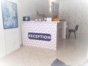 a reception desk in a room with a sign on it at La Marinella in Belvedere Marittimo