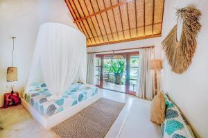 a bedroom with a bed with a mosquito net at Mule Malu Tropical Stay in Uluwatu +37 photos