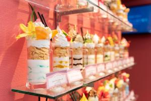 a display of desserts and pastries on a shelf at ホテル チャペルスイート 神戸 三宮 元町 in Kobe