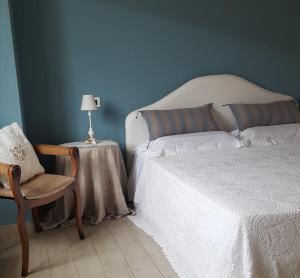 a bedroom with a bed and a table and a chair at Agriturismo Fioredizucca in Albenga