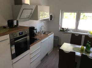 a kitchen with a sink and a stove top oven at Apartment Perla in Limburg an der Lahn