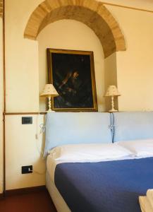 Un pat sau paturi într-o cameră la Vigna del Poggio