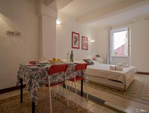 a bedroom with a bed and a table and chairs at Rundanina Village Life Studio plus Single Room with AC in Vernazza +36 photos