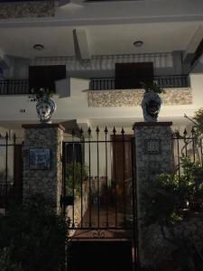 a black gate with vases on top of it at Colapesce in Santa Teresa di Riva