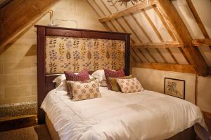 a bedroom with a large bed in a attic at The Cheese House, Gileston Manor in Gileston