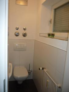 a small bathroom with a toilet and a sink at Ferienwohnung Bartling am Bodensee in Friedrichshafen