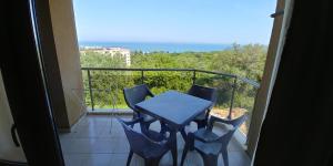 a balcony with a table and chairs on a balcony at Riviera Sea VillageApartments Golden sands in Golden Sands
