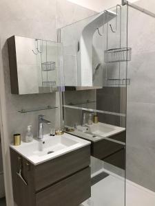 a bathroom with two sinks and a mirror at Les Floralies Capucines in Marseille