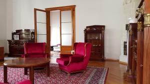 a living room with two chairs and a table at Luxury apartment in the heart of Varazdin in Varaždin
