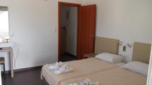 Postel nebo postele na pokoji v ubytování Homer's Inn Hotel