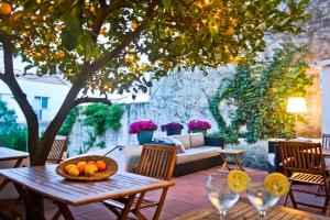 a table with a bowl of fruit on a patio at Hotel Casa Calella in Calella de Palafrugell