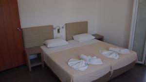 Postel nebo postele na pokoji v ubytování Homer's Inn Hotel