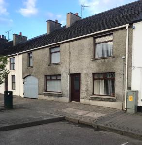 an old brick house with a driveway at Third Tree House in Coleraine