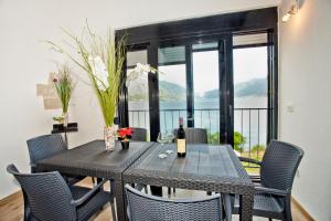 a dining room with a table and chairs with a view at Beachfront Villa Nautica in Kotor