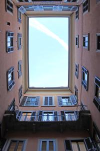 a tall building with a large window in front of it at Torino48 Guesthouse in Milan